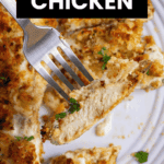 A fork holds a piece of Parmesan Crusted Chicken above a plate with more golden, crispy chicken pieces.