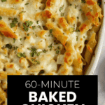 Golden baked Chicken Alfredo Pasta in a casserole dish, topped with melted cheese and sprinkled with herbs.