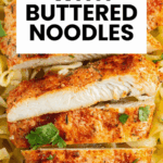 Pan-seared chicken breast served over buttered herb noodles, garnished with fresh herbs.