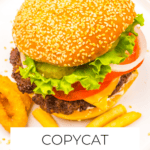 A sesame seed burger with lettuce, tomato, onion, fries, and onion rings on a plate, labeled "Copycat Whopper"—your go-to Whopper recipe inspired by the classic Burger King Whopper.