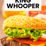Hand holding a sesame seed bun cheeseburger with lettuce, tomato, and cheese; "Easy Burger King copycat Whopper" recipe.