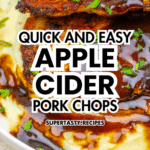 Glazed Pork Chops with apple cider sauce rest on creamy mashed potatoes, garnished with fresh herbs on a white plate.