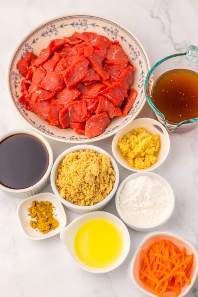 Sliced raw beef, broth, soy sauce, brown sugar, garlic, oil, curry powder, cornstarch, and shredded carrots.