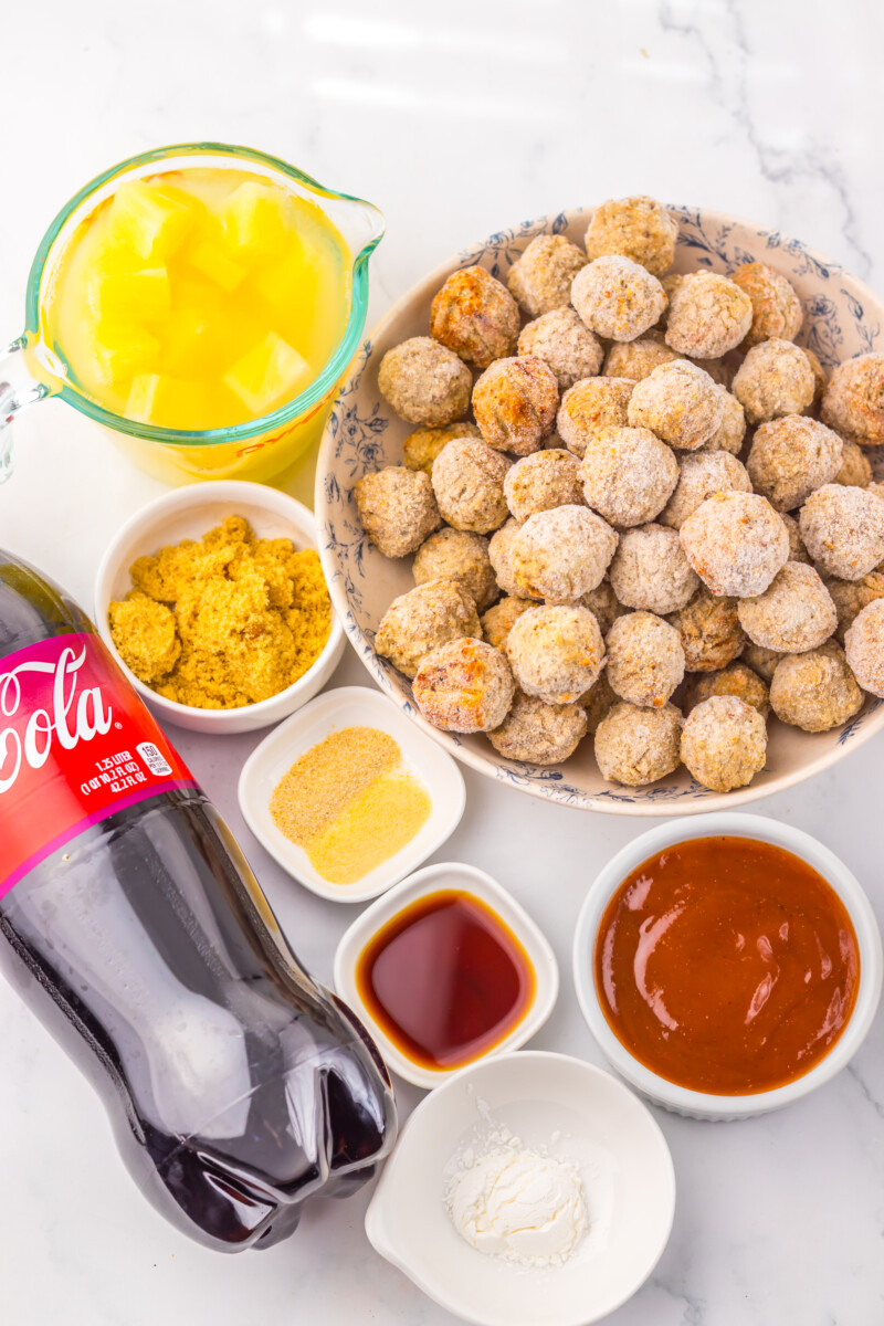 Ingredients for slow cooker cherry cola pineapple BBQ meatballs including frozen meatballs, cola, pineapple juice, BBQ sauce, and spices