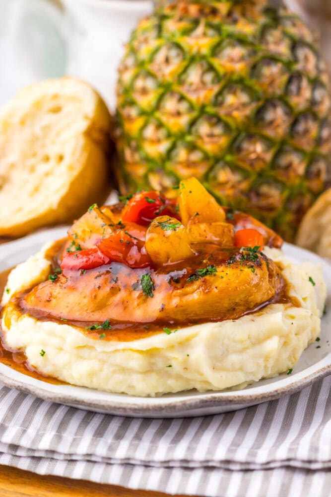 Slow cooker sweet chili pineapple chicken with mashed potatoes and pineapple garnish