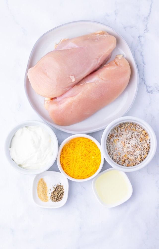 Sour cream and onion chicken ingredients - raw chicken breasts and measured components ready for cooking