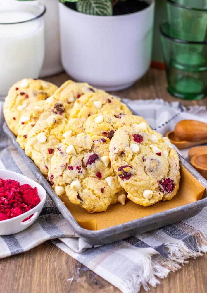 Copycat Subway Raspberry Cheesecake Cookies with white chocolate chips and freeze-dried raspberries on wooden serving board