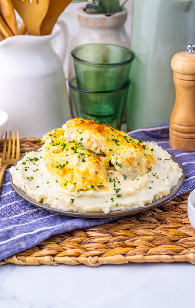 Creamy chicken Caesar bake with golden chicken breasts on mashed potatoes garnished with parsley