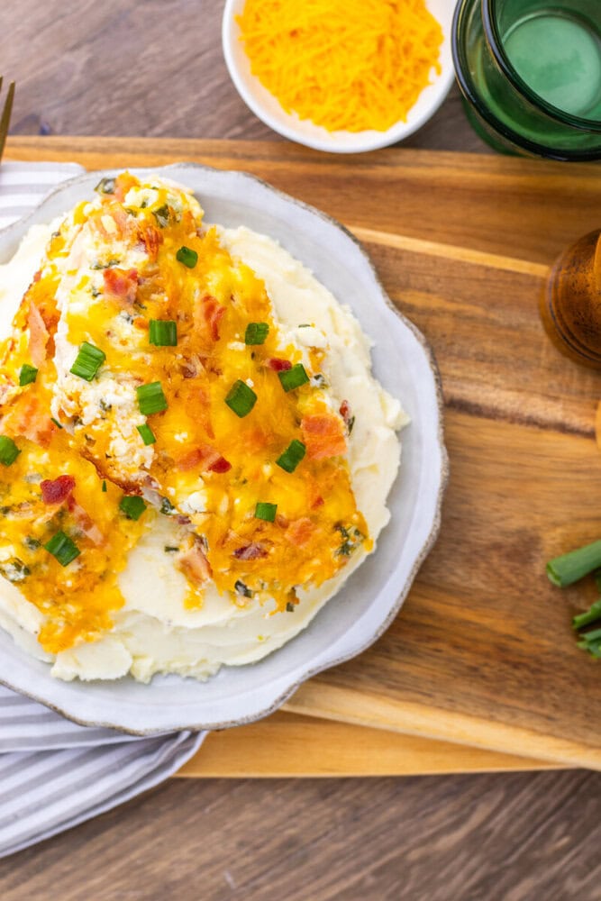 Million Dollar Baked Chicken Breast with cheddar cheese, bacon, and green onions on mashed potatoes