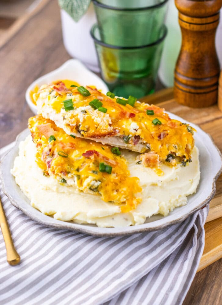 Million Dollar Baked Chicken Breasts with cheese and bacon on mashed potatoes