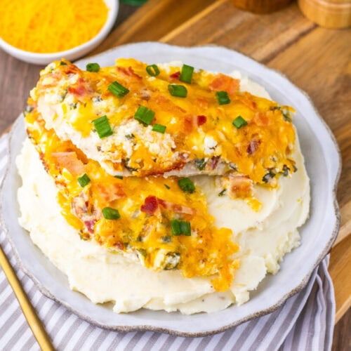 Million Dollar Baked Chicken Breasts with cheese and bacon topping on mashed potatoes
