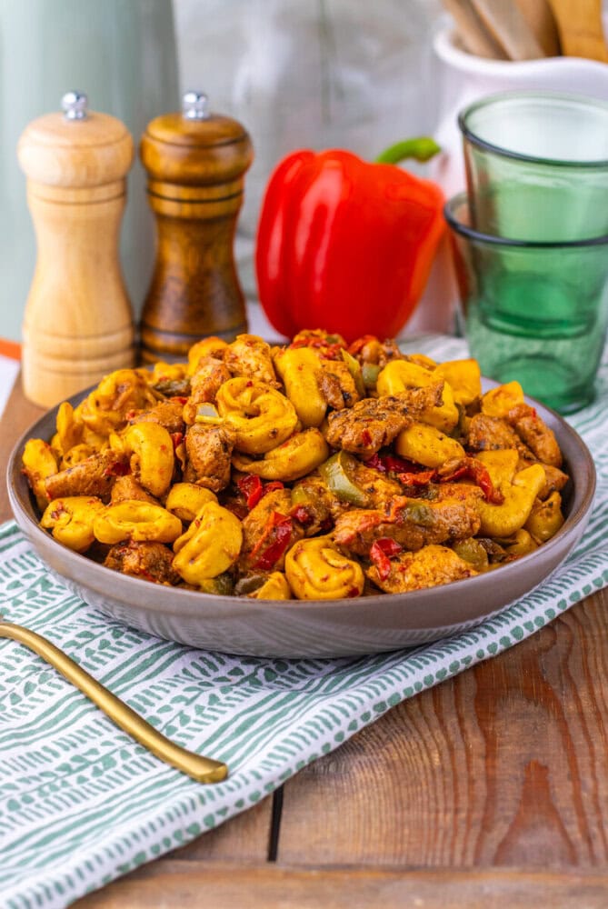 Southwest Ranch Chicken Tortellini with roasted potatoes and red peppers served in a gray bowl