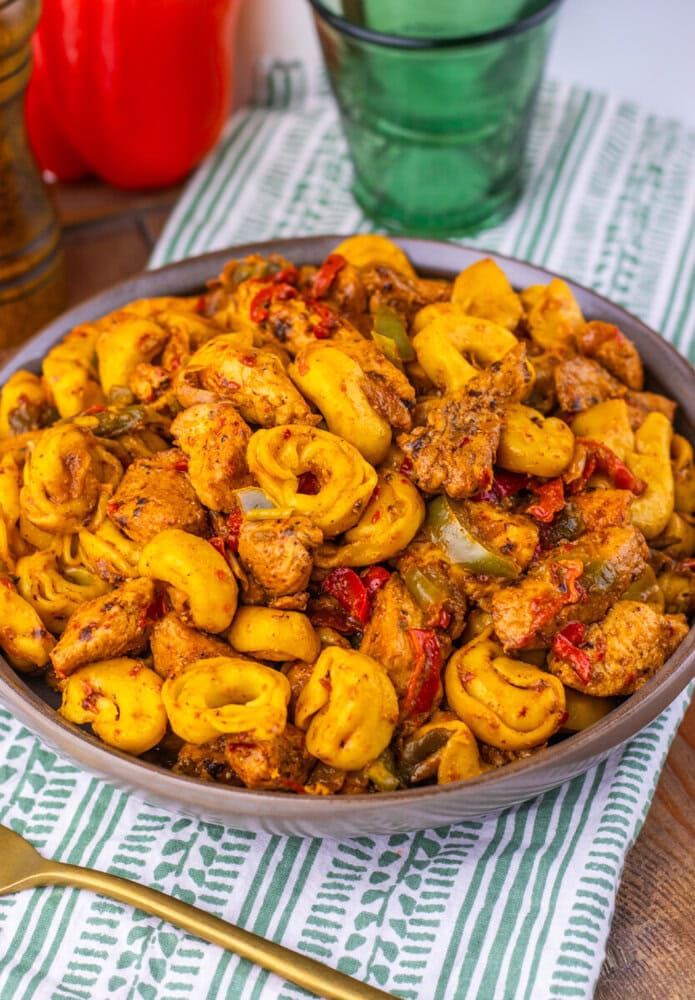 Southwest Ranch Chicken Tortellini with cashews and peppers served in a bowl with green beverage