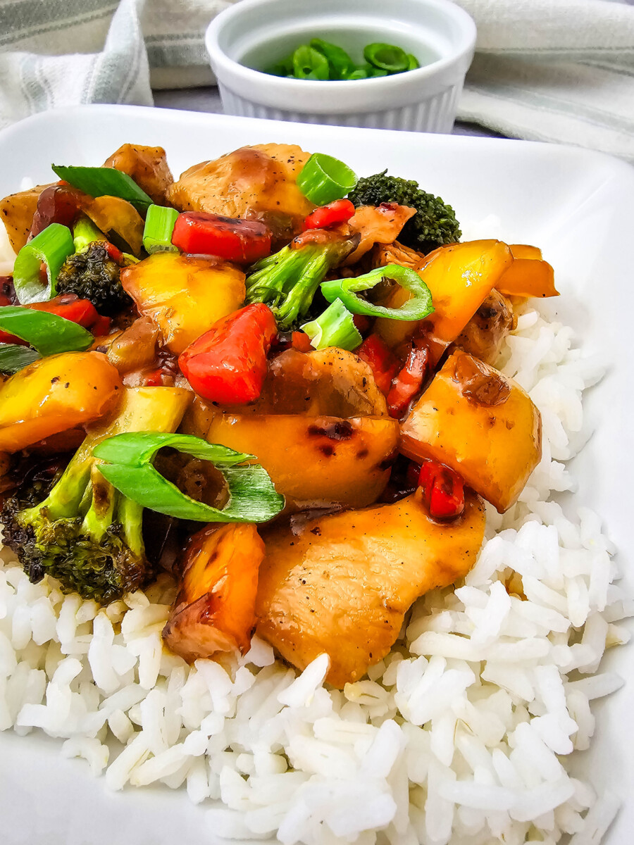 Teriyaki chicken and rice bowl with glazed chicken, broccoli, bell peppers, and scallions over white rice