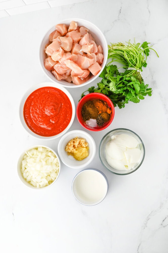 Slow Cooker Chicken Tikka Masala ingredients laid out in bowls ready for cooking