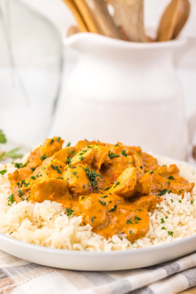 Slow cooker chicken tikka masala served over rice with cilantro garnish
