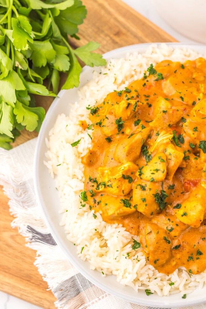 Slow cooker chicken tikka masala served over white rice with cilantro garnish