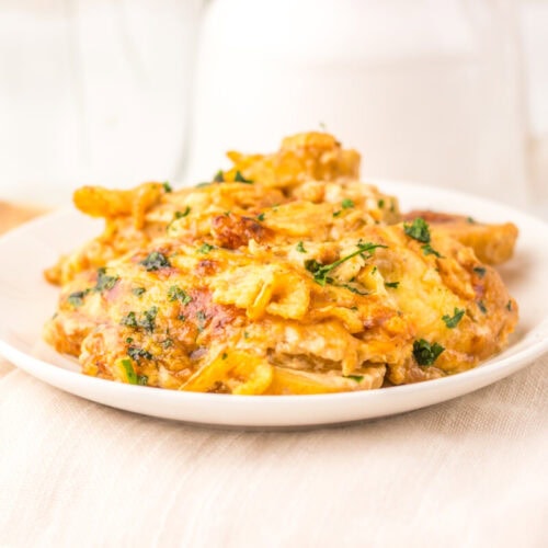 Cheesy French Onion Potato Casserole plated and garnished with parsley
