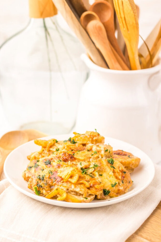 Cheesy French Onion Potato Casserole plated and garnished with fresh parsley