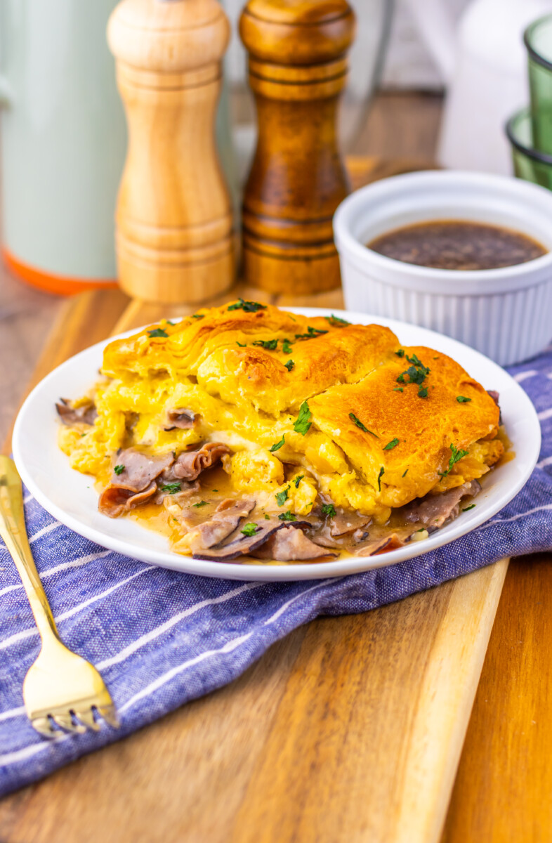 French Dip Biscuit Casserole with golden biscuit topping and roast beef, served with au jus sauce