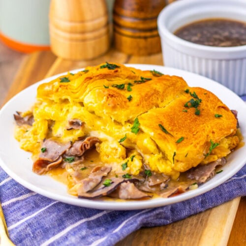 French Dip Biscuit Casserole with golden biscuit topping and roast beef filling, served with au jus sauce