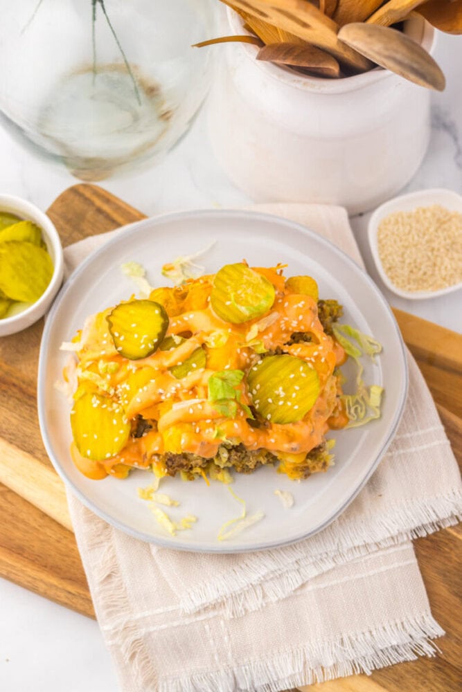 Slow Cooker Big Mac Tater Tot Casserole plated with pickles and sesame seeds