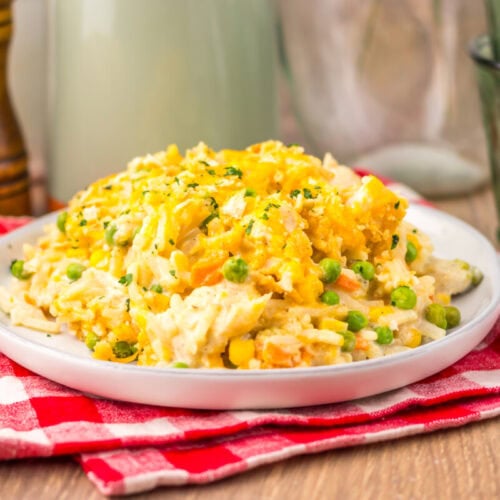 Slow cooker chicken pot pie hash brown casserole with corn and peas served on white plate