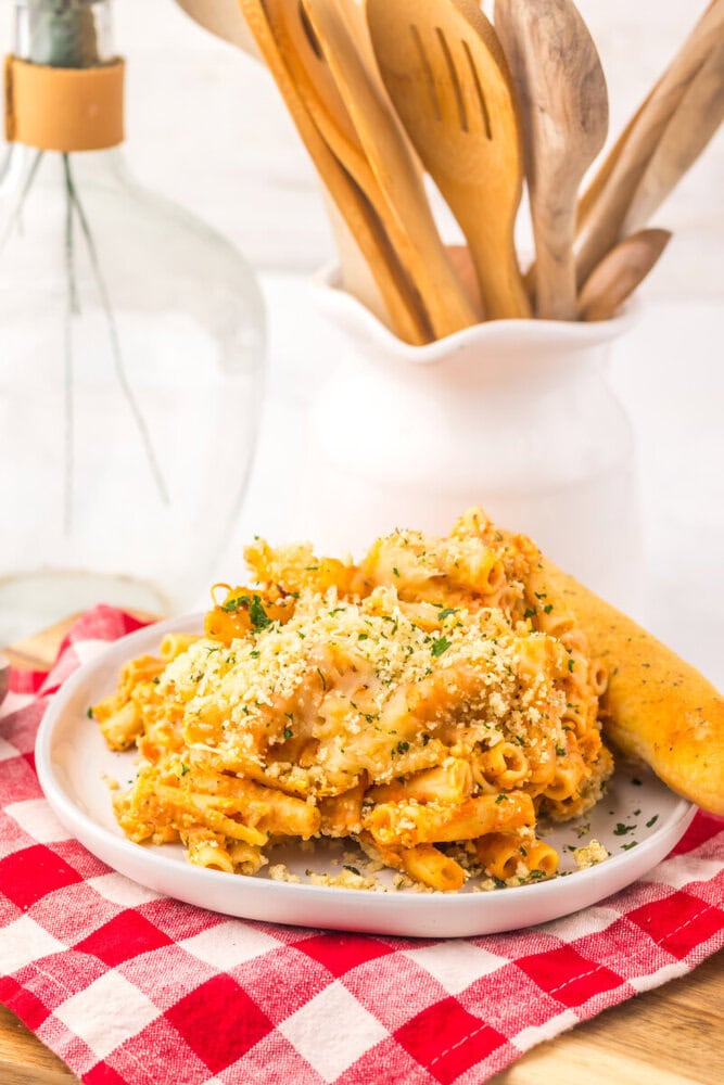 Slow Cooker Five Cheese Ziti Al Forno plated on white dish with breadcrumb topping and herb garnish
