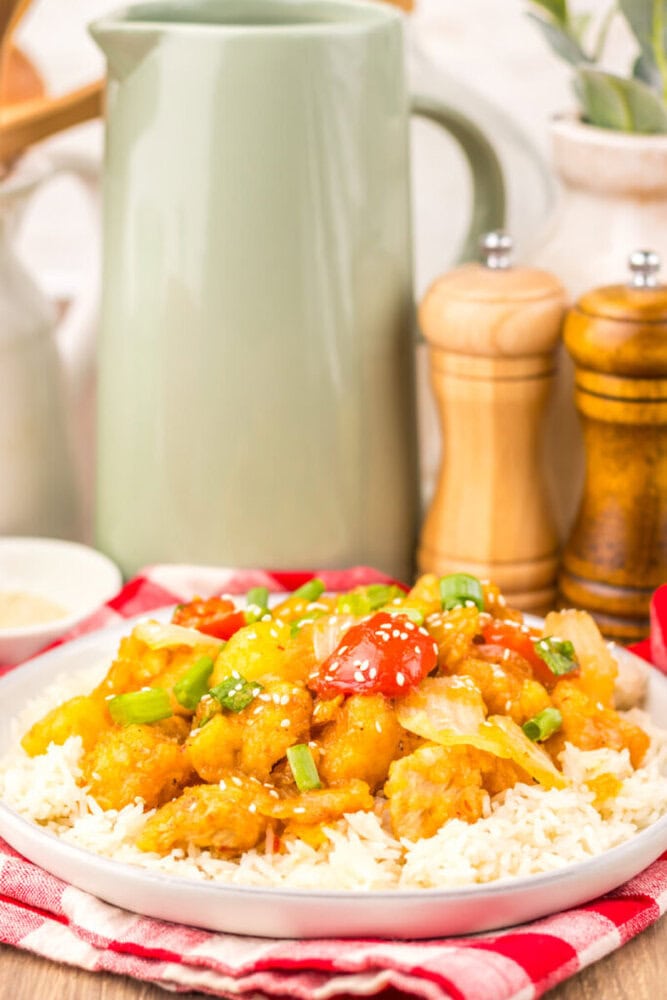 Slow Cooker Copycat Panda Express Sweet Fire Chicken served over rice with sesame seeds and scallions