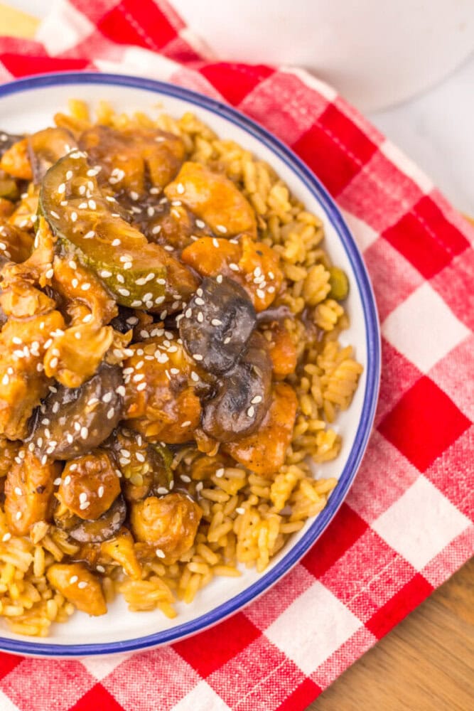 Slow cooker panda express mushroom chicken with sesame seeds served over pasta