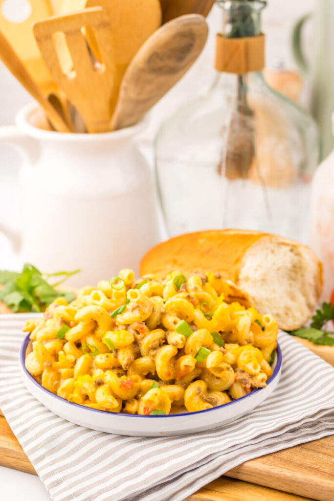 Slow Cooker Rotel Pasta - creamy mac and cheese with green onion garnish plated and ready to serve