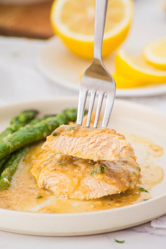 Lemon garlic chicken breast with creamy sauce and green beans plated and ready to serve