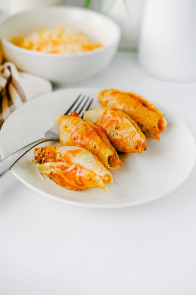 Cheesy taco stuffed shells plated and ready to eat with melted cheese topping