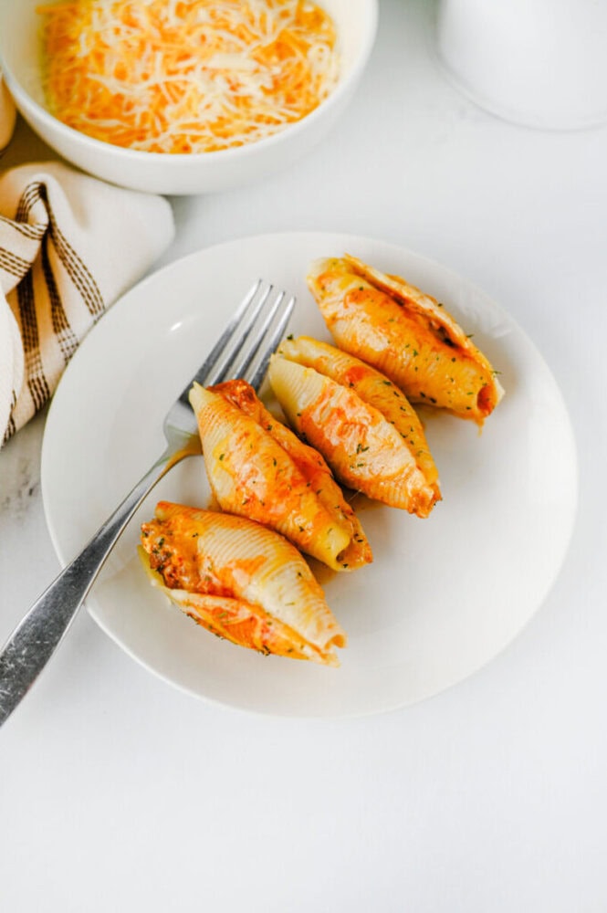 Cheesy taco stuffed shells plated and ready to serve with melted cheese topping