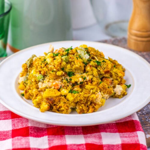 Chicken and corn casserole plated on white dish with fresh herb garnish
