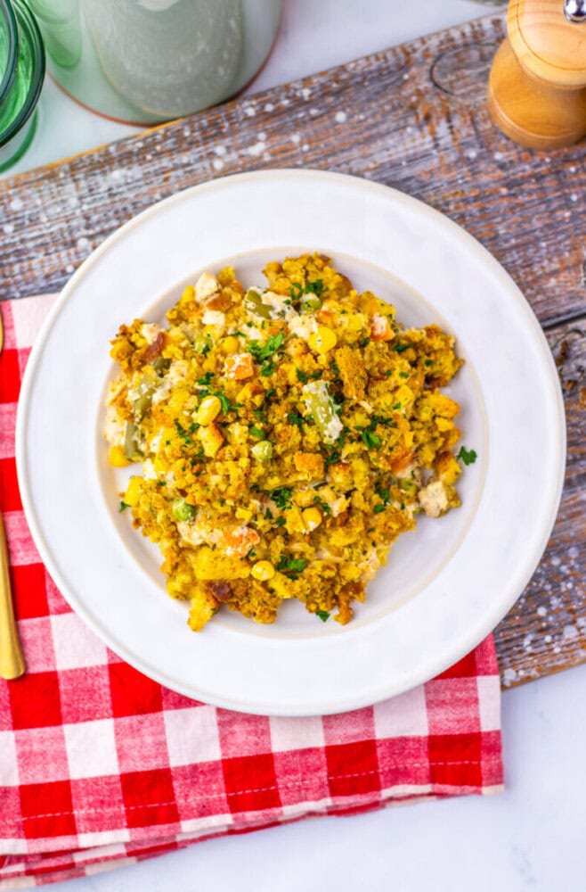 Chicken and corn casserole with parsley garnish plated on white dish
