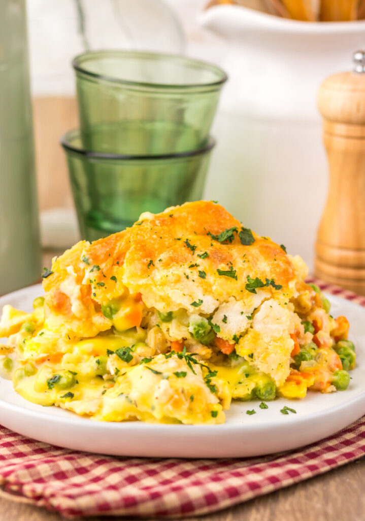 Chicken cobbler with golden biscuit topping and chive garnish plated and ready to serve