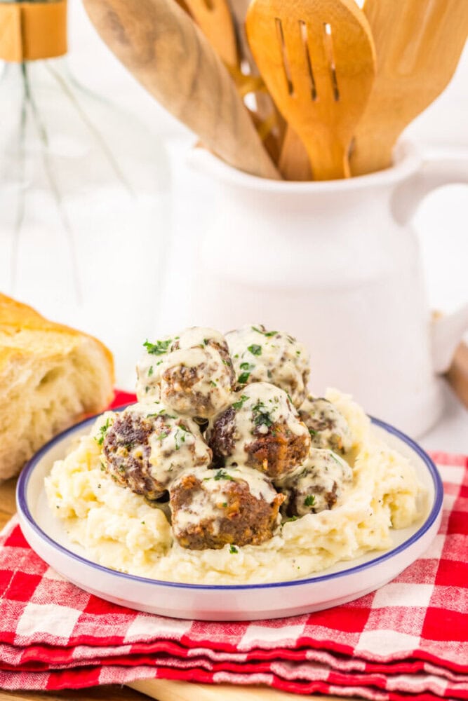 Cowboy butter meatballs served over creamy egg noodles with fresh parsley garnish on a plated dish