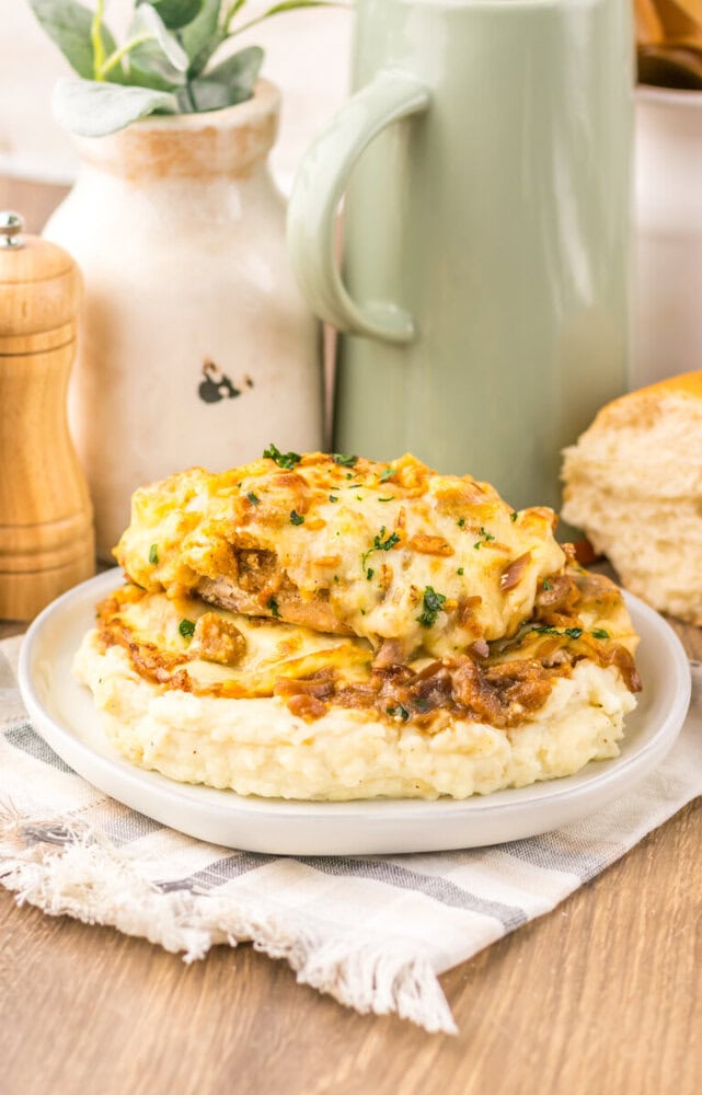 French Onion Chicken Bake with melted cheese and caramelized onions on creamy mashed potatoes