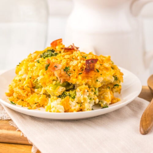 Loaded broccoli rice casserole with golden-brown top garnished with herbs, plated and ready to serve