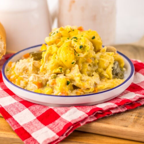 Slow cooker chicken and dumplings pot pie plated and ready to serve with fresh herbs garnish