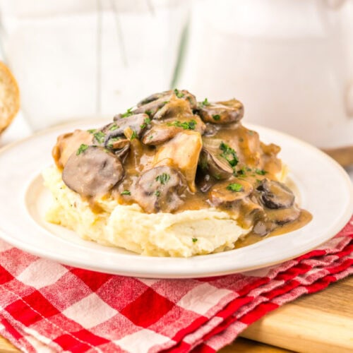 Slow cooker Salisbury chicken with mushroom sauce over mashed potatoes, plated and ready to serve