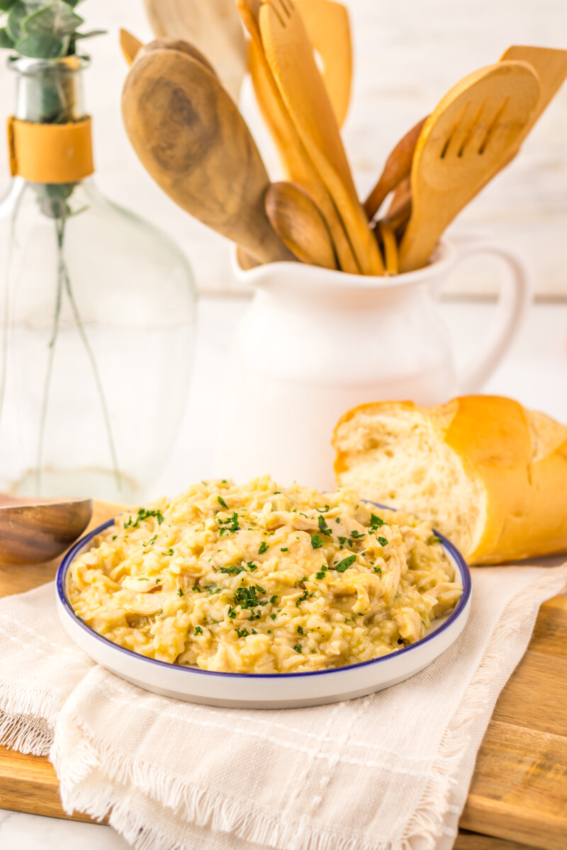 Slow cooker creamy butter chicken and rice garnished with parsley, plated and ready to serve