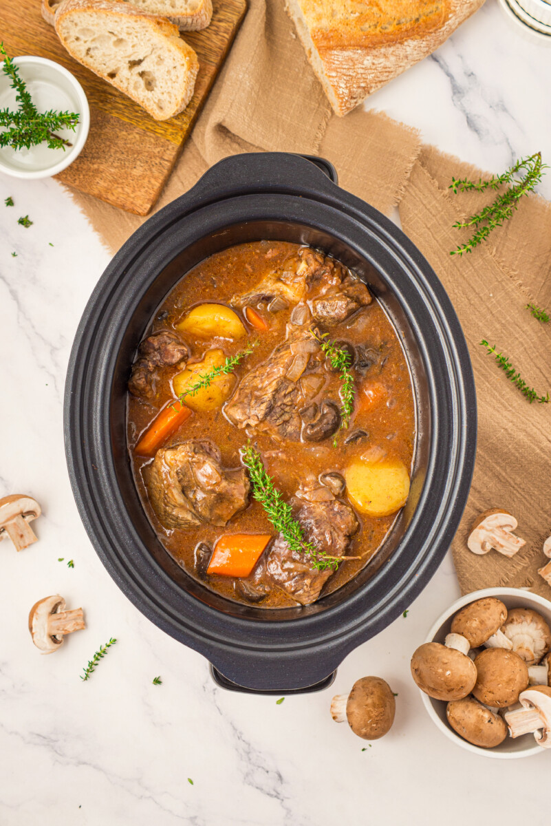 Slow cooker beef pot roast with potatoes and carrots in rich gravy, ready to serve