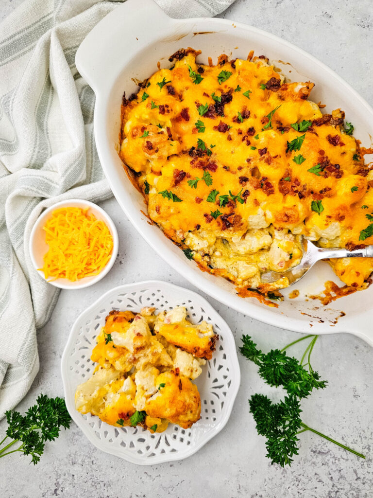 Baked cauliflower casserole with cheese and bacon garnish, served with plated portion