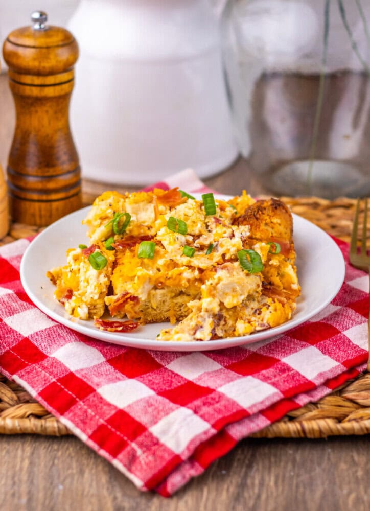 Chicken Bacon Ranch Bubble Up Bake plated on white dish with green onion garnish and checkered napkin