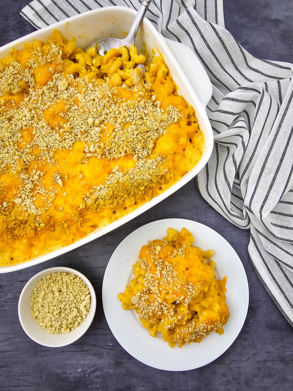 Baked crab mac and cheese with golden sauce and panko topping in white casserole dish