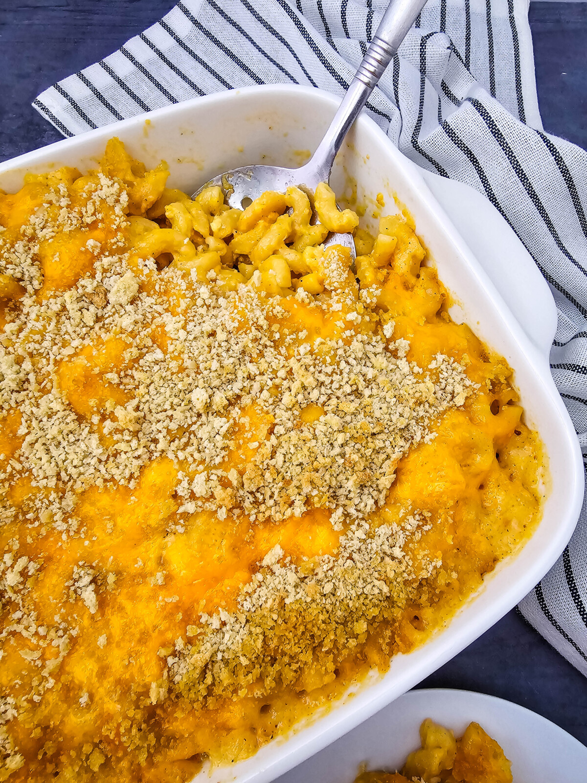 Baked crab mac and cheese casserole with breadcrumb topping in white dish