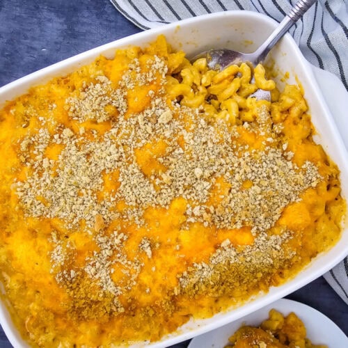 Baked crab mac and cheese with breadcrumb topping in white casserole dish