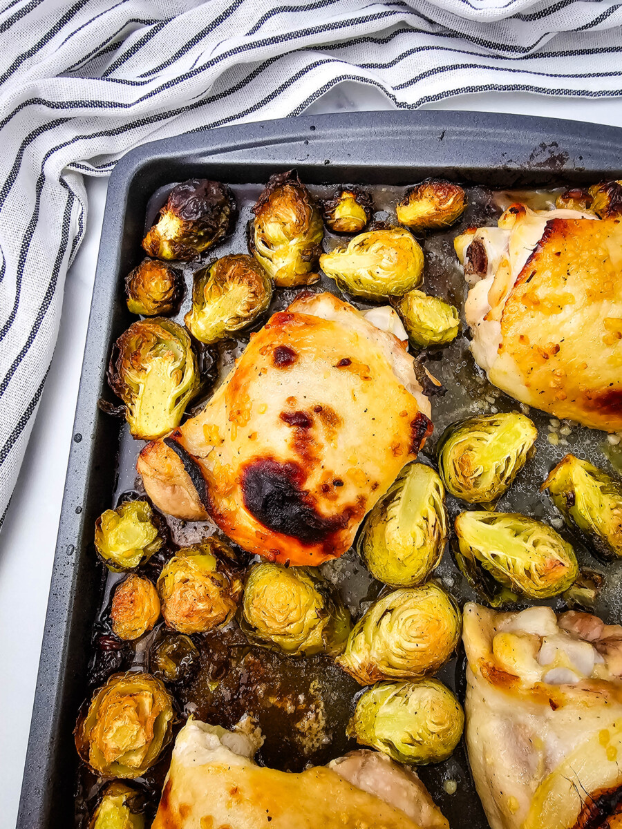 Honey mustard sheet pan chicken thighs with roasted Brussels sprouts, fully cooked and ready to serve